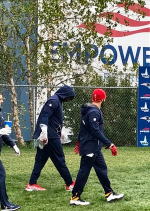 Jamie Collins walked out to practice with plastic hands over his hands.