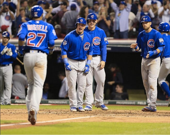 The Chicago Cubs’ Addison Russell comes home after hitting a grand slam in the third inning. (Bob Rossiter/The Repository)