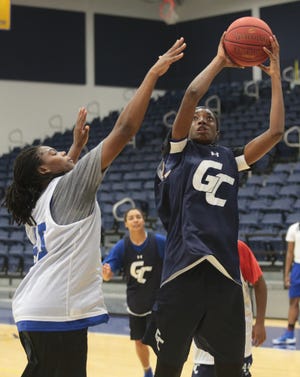 Gulf Coast's Jhileiya Dunlap (right) puts up a shot during a practice Wednesday. HEATHER HOWARD/The News Herald