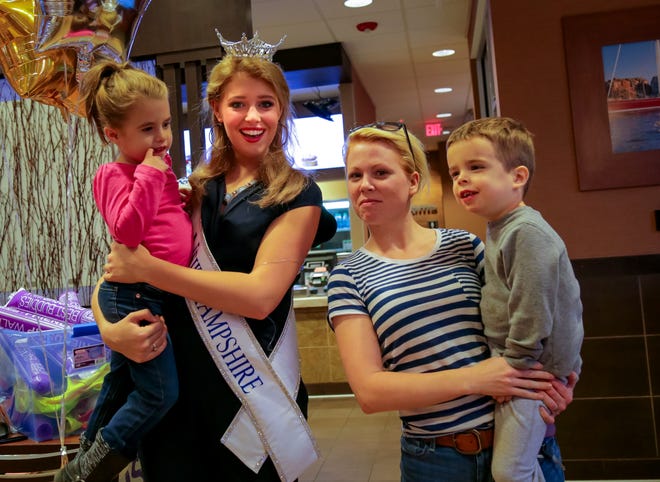 Morgan Day, 5, left, of Rollinsford, Miss NH Caroline Carter, Jenn Brown, and Matthew Day, 3, of Rollinsford pose for a picture Wednesday afternoon during the Best Buddies New Hampshire Meet and Greet with Miss N.H. at McDonald's in Dover. Photo by Shawn St.Hilaire/Fosters.com