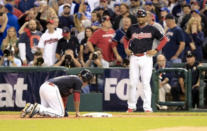 Jose Ramirez on his knees after being picked off at first base in the bottom of the second inning. (Bob Rossiter/The Repository)