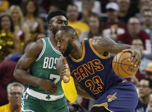 Cavaliers star LeBron James drives on Celtics rookie Jaylen Brown during the first half of game on Thursday night in Cleveland. AP PHOTO/RON SCHWANE