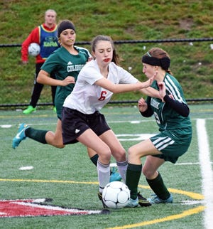 Newmarket High School forward Nicole Berry (6) and Colebrook's Makaila Weir make contact during their Division IV semifinal game in Laconia on Thursday.