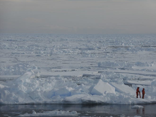 In this image taken April 4, 2015, people are seen walking on the ice in the Arctic near Svalbard, Norway. At current carbon emission levels, the Arctic will likely be free of sea ice in September around mid-century. Photo/Dirz Notz via AP