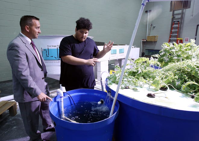 Dr. Mike Daria, Tuscaloosa City School's superintendent, listens as Justin Hobson, a junior at Central, gives him an overview of some of the things he has learned in the Aquaponics Lab during the open house for the lab at Tuscaloosa Career and Technology Academy in Tuscaloosa on Thursday, Nov. 3, 2016.  Staff Photo/Erin Nelson