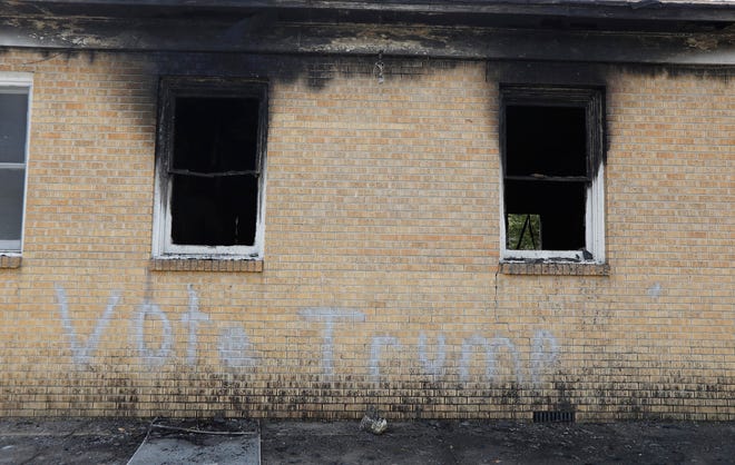 “Vote Trump” is spray painted on the side of the fire damaged Hopewell M.B. Baptist Church in Greenville, Miss., Wednesday, Nov. 2, 2016. Fire Chief Ruben Brown tells The Associated Press that firefighters found flames and smoke pouring from the sanctuary of the church just after 9 p.m. Tuesday. (AP Photo/Rogelio V. Solis)