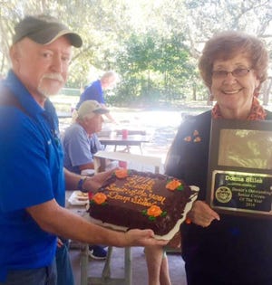 Pat Markey, the city of Destin Seniors Coordinator, surprises Donna Stiles with a plaque and cake recognizing her as the Outstanding Senior Citizen of the Year. SPECIAL TO THE LOG