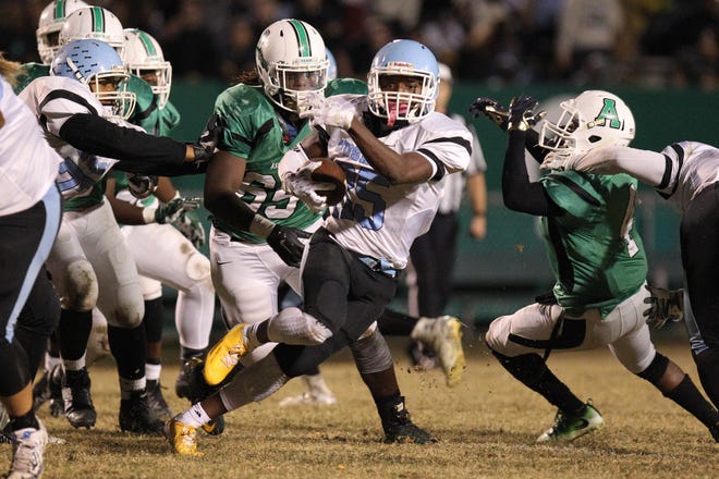 Hunter Huss running back Jaquavious Butler bursts through the Ashbrook defensive line Friday nght. The Huskies defeated the Green Wave in the Battle of the Bell, finishing undefeated in the Big South 2A/3A Conference. Brian Mayhew/Special to the Gazette