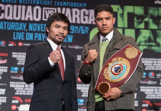 Boxers Manny Pacquiao, left, and Jessie Vargas pose at a news conference Wednesday, Nov. 2, 2016, in Las Vegas, for their Saturday bout for Vargas' WBO welterweight title. (Loren Townsley/Las Vegas Review-Journal via AP)
