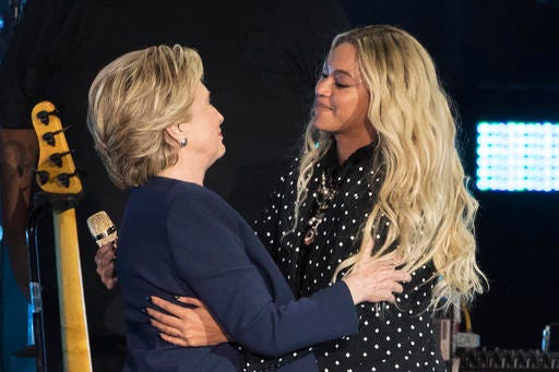 Beyonce, right, and Democratic presidential candidate Hillary Clinton embrace during a campaign rally in Cleveland, Friday, Nov. 4, 2016. (AP Photo/Matt Rourke)