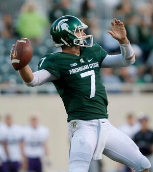FILE - In this Oct. 15, 2016, file photo, Michigan State quarterback Tyler O'Connor throws a pass against Northwestern during the fourth quarter of an NCAA college football game, in East Lansing, Mich. Looking at the schedule back in August, Michigan State-Illinois was not a game many people would have guessed would pit a pair of 2-6 teams against each other. (AP Photo/Al Goldis, File)