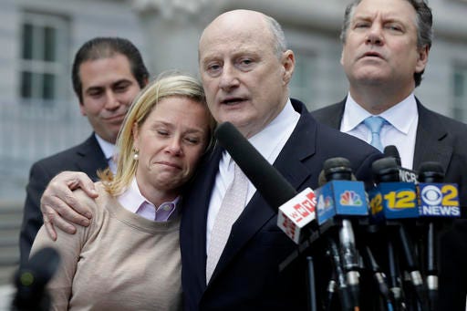 Bridget Anne Kelly, left, former Deputy Chief of Staff for New Jersey Gov. Chris Christie, is held by her lawyer Michael Critchley while talking to reporters after she was found guilty on all counts in the George Washington Bridge traffic trial at Martin Luther King, Jr., Federal Court, Friday, Nov. 4, 2016, in Newark, N.J. (AP Photo/Julio Cortez)