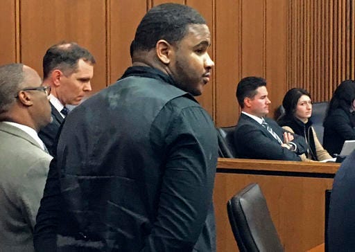 Douglas Shine Jr., front center, stands with attorneys as a verdict is read in his trial Friday, Nov. 4, 2016, at the Cuyahoga County Justice Center in Cleveland. Shine, accused of killing three people at a barbershop outside Cleveland, was found guilty on Friday of aggravated murder and other charges and could face the death penalty. (AP Photo/Mark Gillispie)