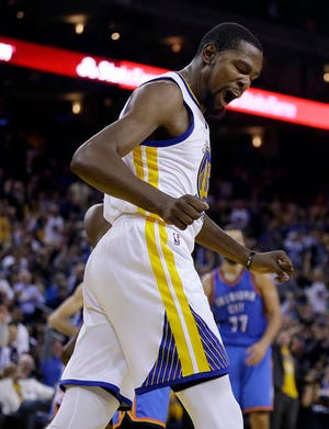Golden State Warriors' Kevin Durant celebrates after scoring against the Oklahoma City Thunder during the second half of an NBA basketball game Thursday, Nov. 3, 2016, in Oakland, Calif. (AP Photo/Ben Margot)
