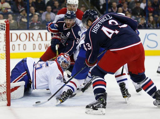 Columbus Blue Jackets forward Scott Hartnell, right, takes a shot against Montreal Canadiens goalie Al Montoya during the second period of an NHL hockey game in Columbus, Ohio, Friday, Nov. 4, 2016. Hartnell scored on the play. (AP Photo/Paul Vernon)