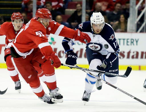 Detroit Red Wings center Frans Nielsen (51), of Denmark, tries to chase down the puck against Winnipeg Jets center Adam Lowry (17) during the first period of an NHL hockey game Friday, Nov. 4, 2016, in Detroit. (AP Photo/Duane Burleson)