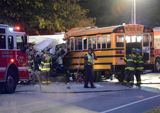 FILE - In this Tuesday, Nov. 1, 2016 file photo, fire department and rescue officials work at the scene of an early morning fatal collision between a school bus and a commuter bus in Baltimore. The Maryland Motor Vehicle Administration says the driver of a Baltimore school bus involved in a deadly crash with a commuter bus shouldn't have been driving the vehicle because his commercial license had been suspended two months earlier. Glenn Chappell, 67, was killed Tuesday, along with a Maryland Transit Administration bus driver and four mass transit passengers, when his school bus crossed the center line and smashed into the commuter bus. (Jeffrey F. Bill/The Baltimore Sun via AP, File)