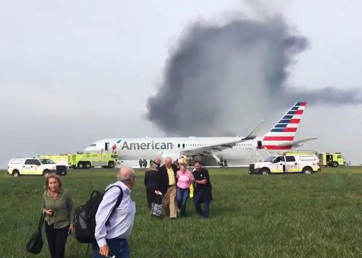 FILE - In this photo provided by passenger Jose Castillo, taken Oct. 28, 2016, fellow passengers walk away from a burning American Airlines jet that aborted takeoff and caught fire on the runway at Chicago's O'Hare International Airport. An engine disk that broke apart and forced an American Airlines jet to abort a takeoff in Chicago last week shows signs of fatigue cracking, according to a preliminary report released Friday, Nov. 4, 2016, by accident investigators. (Jose Castillo via AP)