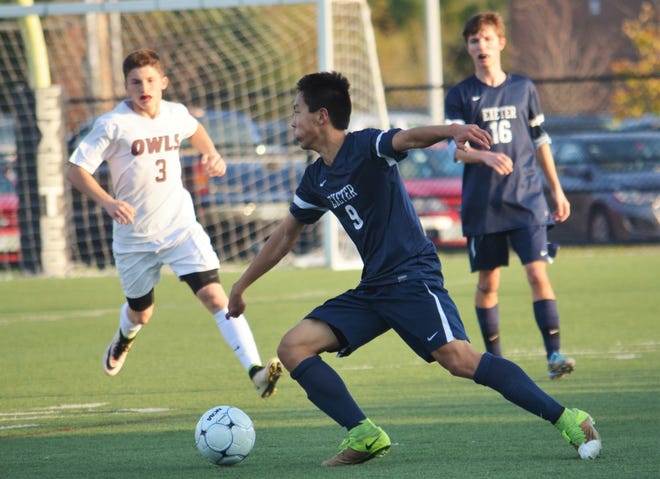 The play of senior Eddie Zhao (9) and the other defenders on the Exeter High School boys soccer team has been critical during an eight-game win streak that has the Blue Hawks playing in today's Division I state championship game. 

Photo by Ryan O'Leary/Seacoastonline