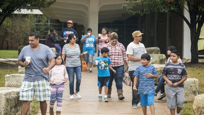 Families make their way from Lanier High School on Saturday after meeting there with Austin school district officials about T. A. Brown Elementary school’s indefinite closure. An engineer found serious structural problems with the building’s floor this week.