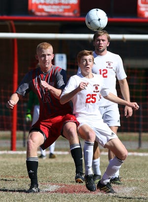 St. Stephens' Garrett Logan, left, and South Point's Jacob Boyd vie for the ball in the first half of Saturday afternoon's high school soccer playoff game in Belmont. MIKE HENSDILL/THE GAZETTE