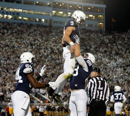 Penn State's Mike Gesicki (88) lifts quarterback Trace McSorley (9) in the air after he scored a touchdown against Iowa during the first half of an NCAA college football game in State College, Pa., Saturday, Nov. 5, 2016. (AP Photo/Chris Knight)