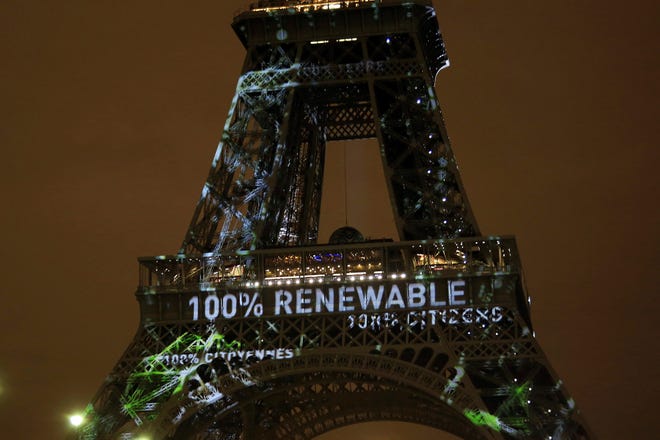 Thibault Camus/AP In this Sunday, Nov. 29, 2015 file photo, an artwork entitled ‘One Heart One Tree’ by artist Naziha Mestaoui is displayed on the Eiffel tower ahead of the 2015 Paris Climate Conference, in Paris. The Paris Agreement on climate change comes into force Friday Nov. 4, 2016, after a year with remarkable success in international efforts to slash man-made emissions of carbon dioxide and other global warming gases. (AP Photo/