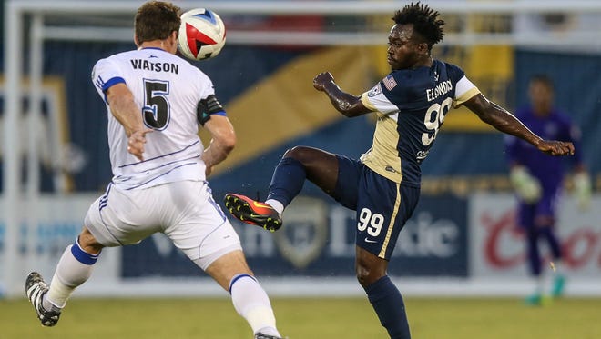 Charles Eloundou (right), shown playing against FC Edmonton in September, is one of five players re-signing with the Jacksonville Armada. (For the Florida Times-Union, Gary Lloyd McCullough) Jacksonville Armada forward Charles Eloundou (99), right, advances the ball defended by Edmonton defender Albert Watson (5) during first half NASL pro-soccer action in Jacksonville, Fla., Wednesday, Sept. 28, 2016. (For the Florida Times-Union, Gary Lloyd McCullough)
