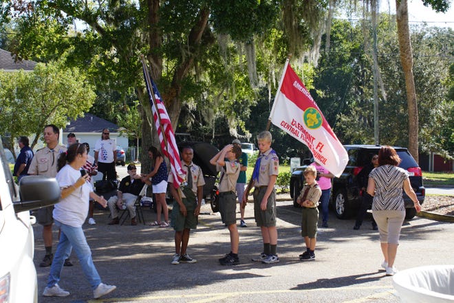 The color guard of Boy Scout Troop 551 (Clermont) waits for that part in the Veterans Day celebration. (LINDA CHARLTON / CORRESPONDENT)