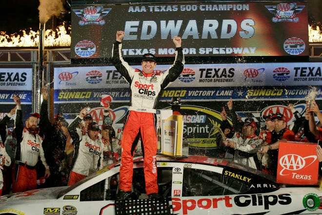 Carl Edwards celebrates in victory lane after winning the NASCAR Sprint Cup Series auto race at Texas Motor Speedway in Fort Worth, Texas, Sunday, Nov. 6, 2016. (AP Photo/LM Otero)