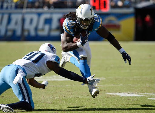 San Diego Chargers running back Melvin Gordon (28) runs with the ball as Tennessee Titans cornerback Perrish Cox defends during the first half of an NFL football game, Sunday, Nov. 6, 2016, in San Diego. (AP Photo/Denis Poroy)