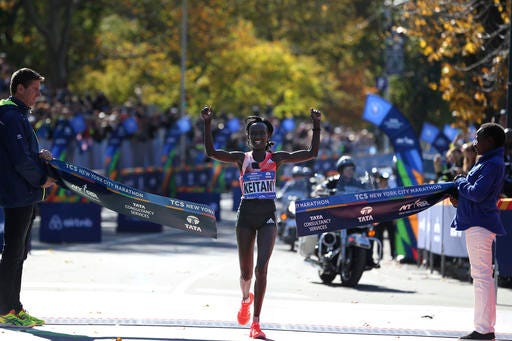 Mary Keitany, of Kenya, crosses the finish line first in the women's division of the 2016 New York City Marathon in New York, Sunday, Nov. 6, 2016. (AP Photo/Seth Wenig)