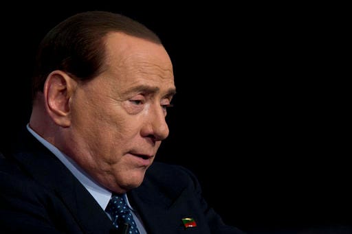 FILE - In this Wednesday, May 21, 2014 file photo, Silvio Berlusconi talks during the recording of a TV show in Rome. If Donald Trump wins the White House on Tuesday, he'll become America's first billionaire businessman to serve as president. But he'll be following in the footsteps of other moguls who have jumped into the political fray elsewhere in the world. Trump has drawn more comparisons to the brash Berlusconi, a three-term Italian prime minister, than perhaps any other world leader. (AP Photo/Andrew Medichini, File)