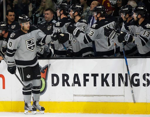 Los Angeles Kings right wing Devin Setoguchi, left, celebrates with teammates after scoring against the Calgary Flames during the first period of an NHL hockey game in Los Angeles, Saturday, Nov. 5, 2016. (AP Photo/Alex Gallardo)