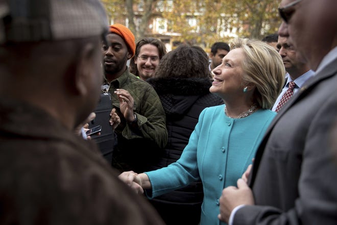 Democratic presidential candidate Hillary Clinton greets people outside Cedar Park Cafe in Philadelphia on Sunday, Nov. 6. (AP Photo/Andrew Harnik)