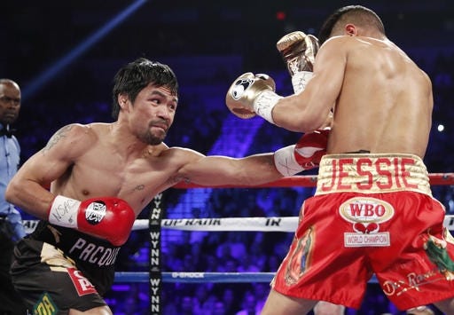 Manny Pacquiao, left, of the Philippines, hits Jessie Vargas during their WBO welterweight title boxing match, Saturday, Nov. 5, 2016, in Las Vegas. THE ASSOCIATED PRESS / ISAAC BREKEN