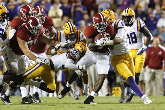 Alabama running back Bo Scarbrough (9) fights through the middle of the LSU defense during the first half. Staff Photo/Gary Cosby Jr.
