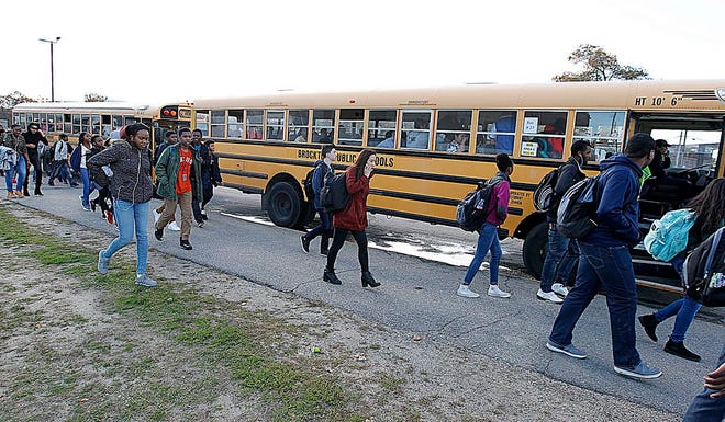 Students leave Brockton High School for waiting buses on Monday, Oct.31, 2016.