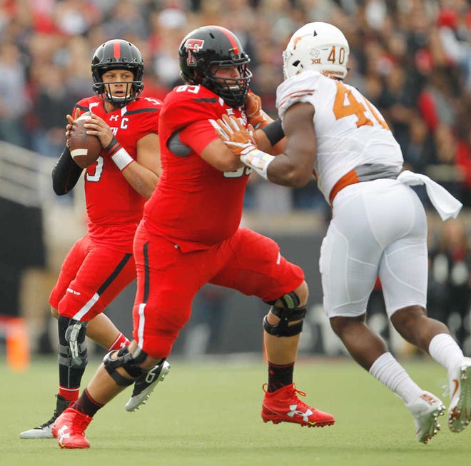 Texas Tech offensive lineman Baylen Brown blocks Texas' Naashon Hughes to give Texas Tech quarterback Patrick Mahomes II more time in the pocket during Tech's 45-37 loss on Saturday.