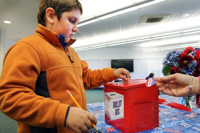 Jacob Piwonski 10, a fifth-grader at the York Middle School puts his ballot in the red box during a school-wide mock election for president Monday, the day before Election Day.

Photo by Rich Beauchesne/Seacoastonline