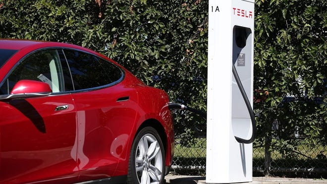 Tesla Motors will begin charging fees for use of its supercharging stations for vehicles ordered after Jan. 1, 2017. Those vehicles will come with about 1,000 miles worth of free charging per year. Tesla has not announced how much it will cost to use the charging stations after hitting the 1,000-mile mark. Vehicles ordered before Jan. 1 will not have to pay to use the stations. (Photo by Justin Sullivan/Getty Images)