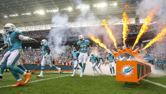 Miami Dolphins players enter the field against the New York Jets during their NFL game Sunday November 06, 2016 at Hard Rock Stadium in Miami Gardens. (Bill Ingram / The Palm Beach Post)