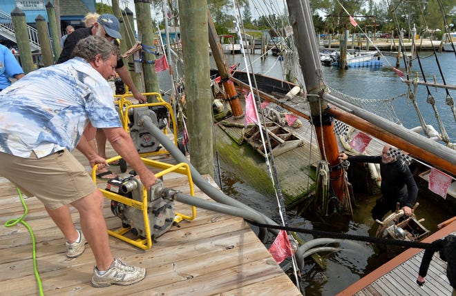 Rick Stewart, founder of Cortez Classic Yacht Guild Inc. positions a pump as crews attempt to raise the 1870 schooner San Francesco, which sank in a marina in Cortez during Hurricane Hermine in September. Stewart formed the non-profit that now owns the San Francesco and will finance the restoration project. He also manages the Florida Institute for Saltwater Heritage Boatworks and restores wooden vessels. Herald-Tribune staff photo / Mike Lang
