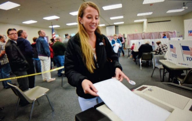 First-time voter Madison Santello casts her ballot in Dover on Tuesday. Photo by John Huff/Fosters.com