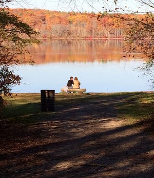 A couple enjoys a quiet interlude at Fisherman's Beach at Ponkapoag Pond in Canton.