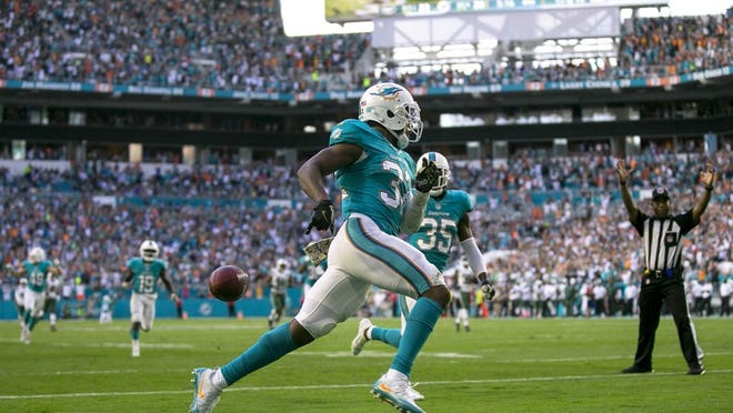 Miami Dolphins running back Kenyan Drake (32), runs back a kickoff for a touchdown making the score 26-23 late in the fourth quarter against the New York Jets during their NFL game Sunday November 06, 2016 at Hard Rock Stadium in Miami Gardens. Final score 27-23. (Bill Ingram / The Palm Beach Post)
