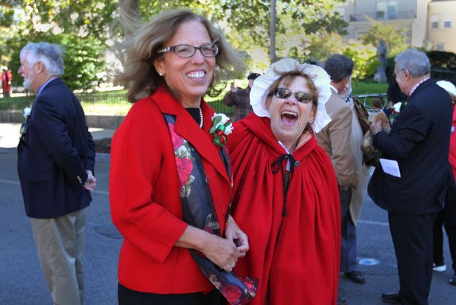 Senate President M. Teresa Paiva Weed, left, laughs with longtime friend Leslie Pine while campaigning at Newport's Columbus Day parade.