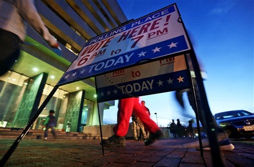 Voters walk into Hampton City Hall to cast their votes before the polls close on Tuesday, Nov. 8, 2016, in Newport News, Va.