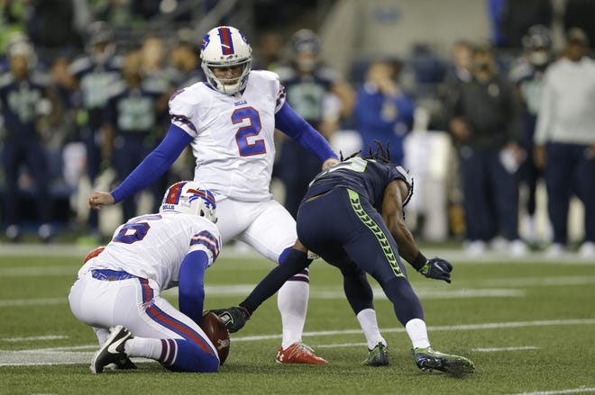 Seahawks cornerback Richard Sherman, right, reaches out to grab the ball on a failed field goal attempt byBills kicker Dan Carpenter as Colton Schmidt holds late in the first half of Monday night's game in Seattle. Sherman was given a defensive offsides penalty on the play. THE ASSOCIATED PRESS / JOHN FROSCHAUER