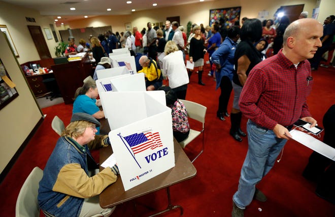 Last minute voters rush to cast their ballots on Election Day at the Christ United Methodist Church precinct in north Jackson, Miss., Tuesday, Nov. 8, 2016. (AP Photo/Rogelio V. Solis)